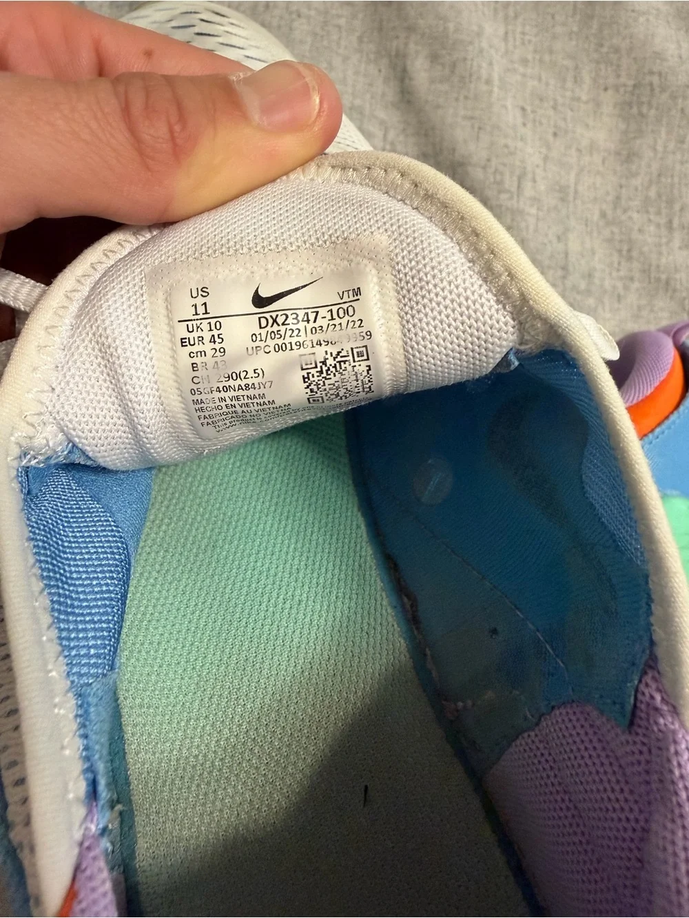 Nike White Running Sneakers with Orange Accents and Purple Lining
